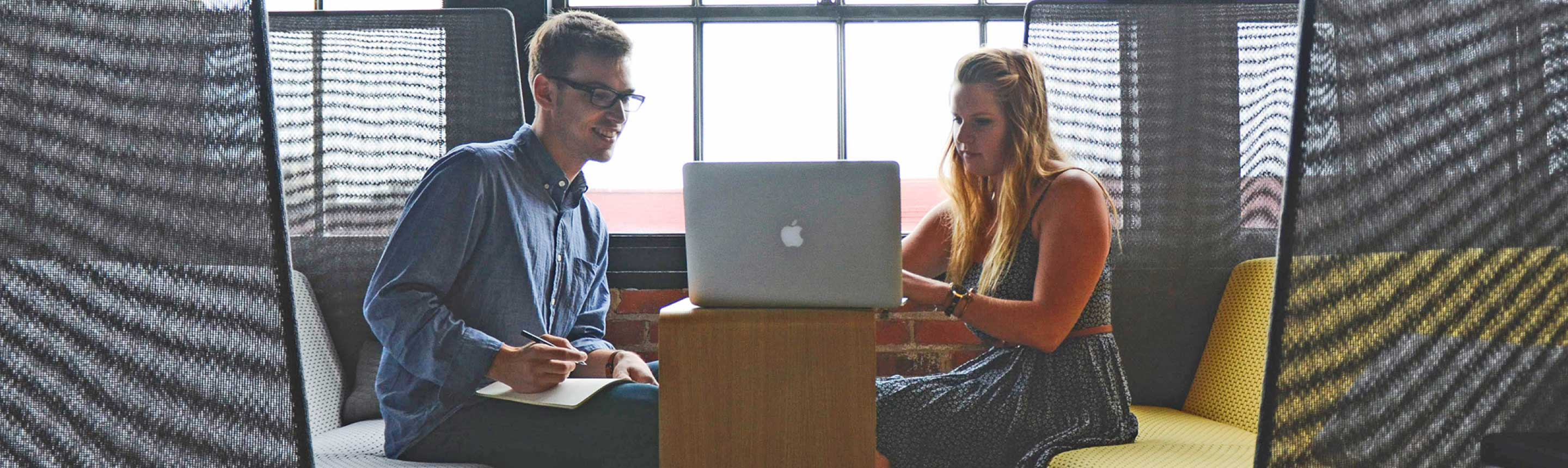 Two business people looking at the laptop.