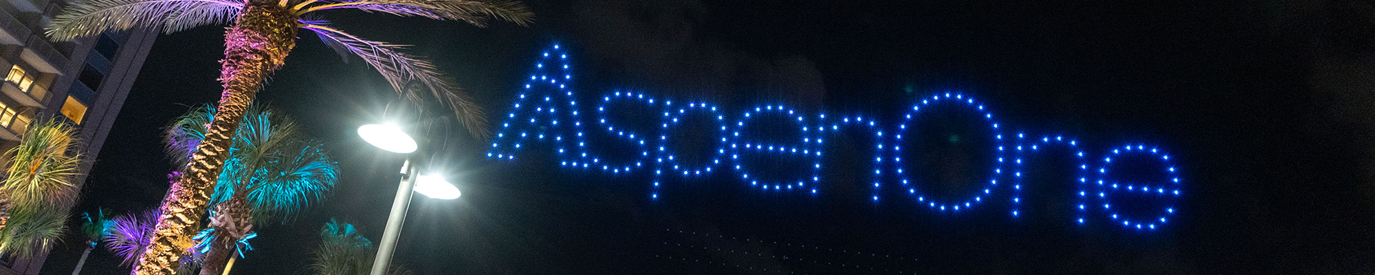 AspenOne written out in small blue lights hanging in the night sky