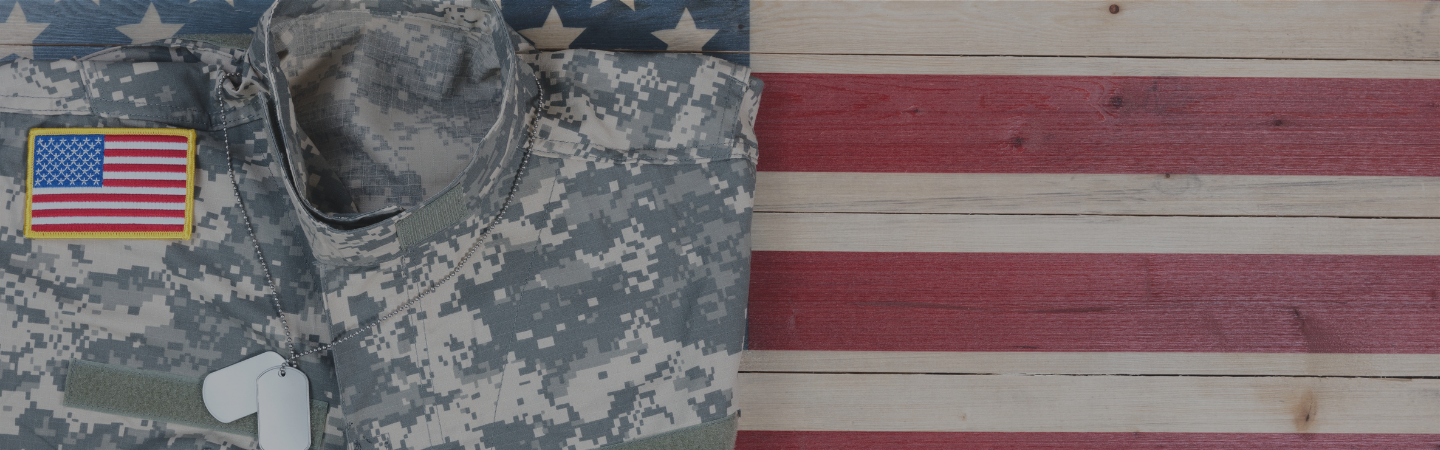 Military uniform resting on a table with stars and stripes painted on it.