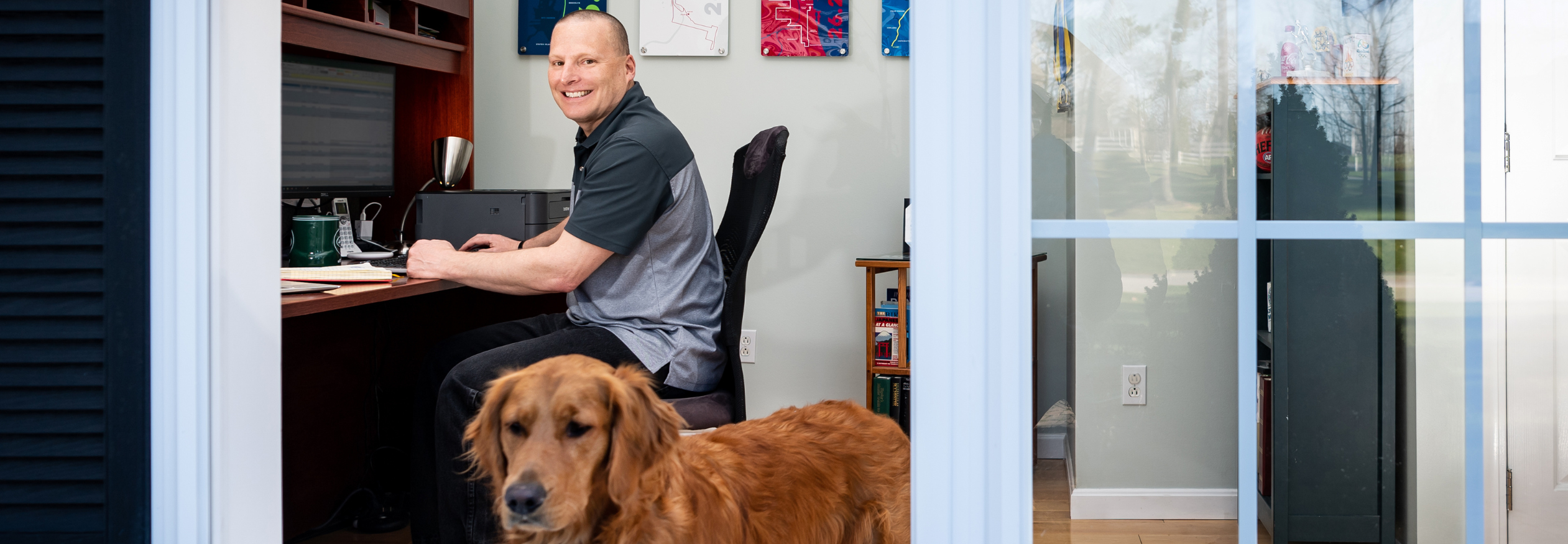 Greg, a BAE Systems employee, and his dog Luna working from home.
