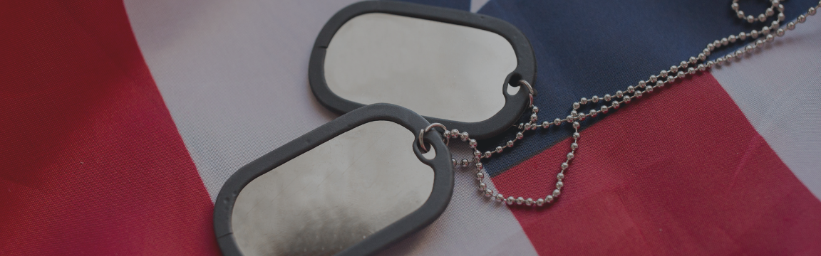 Close up of military dog tags resting on an American flag.