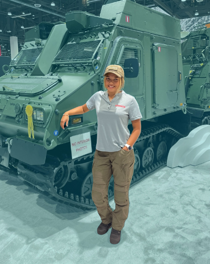 Sofia, a test and verification engineer smiles for a photo in front of a Bvs10.