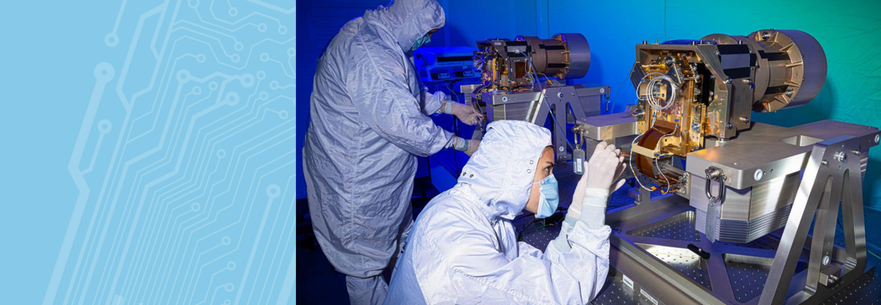 Two electrical engineers work on space tech.