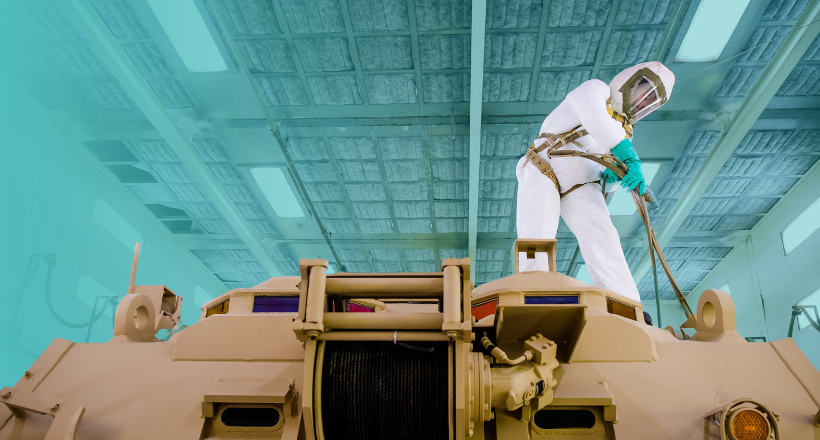 A spray painter works on a combat vehicle at a BAE Systems facility.