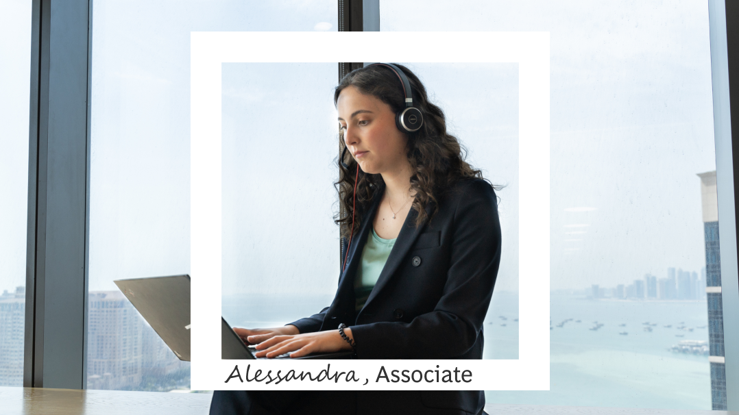 White square frame features black woman with braids sitting typing on a laptop on a background of blue squares.