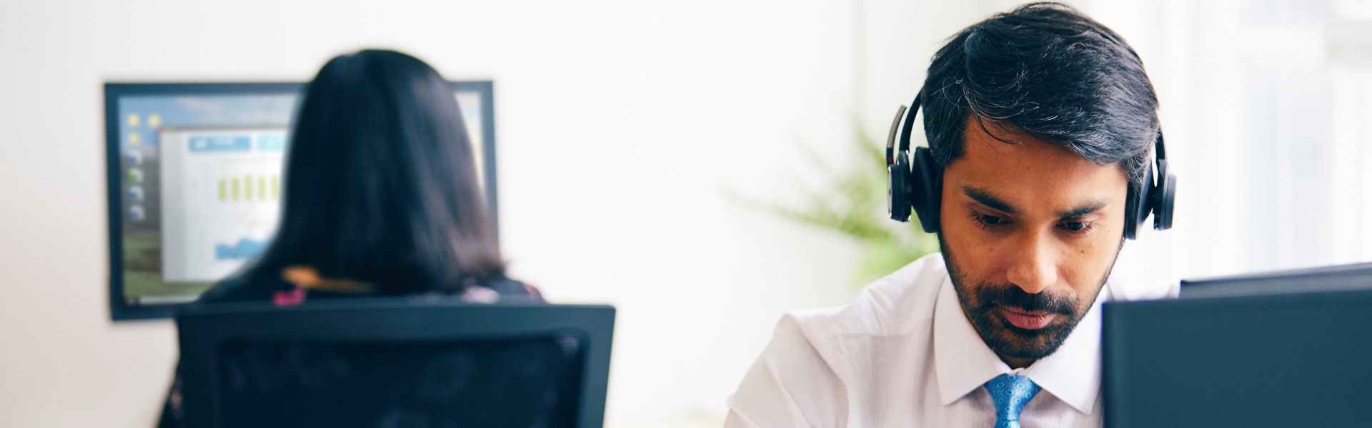 Man working at a desk with headphones