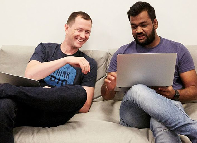 Two Chewy FC team members lifting up a Chewy box