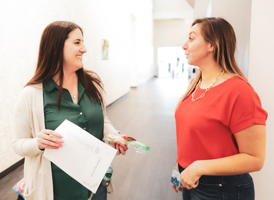 A trainer providing a team member with a certificate