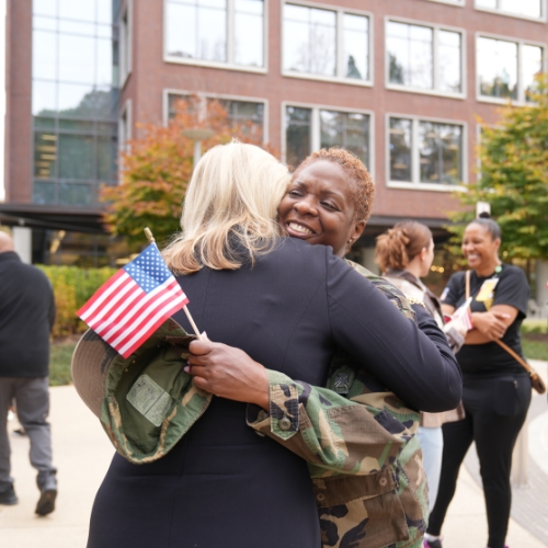 Children’s staff member and veteran hugs CEO Donna Hyland.