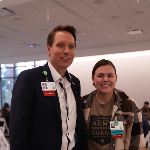 Jeremy Meller, Chief Information Officer and former military, stands with employee and veteran. 