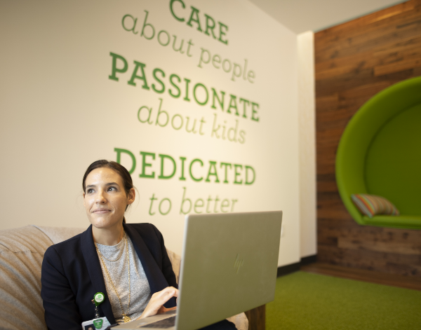 Children’s employee takes online learning course on laptop. 