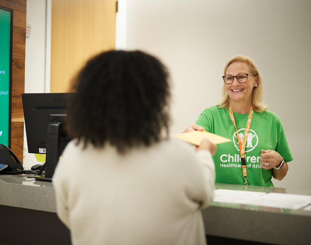 Concierge handing packet to employee