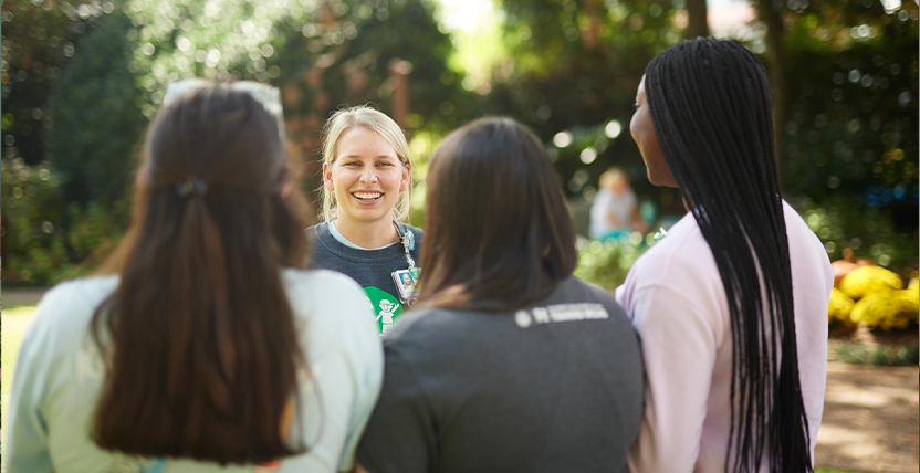 employee talking to group of friends