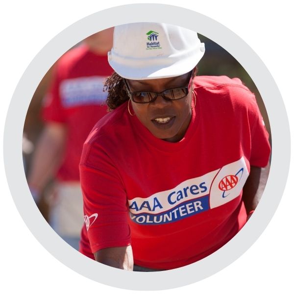 A person wearing an AAA Cares volunteer shirt participating in a community service activity 