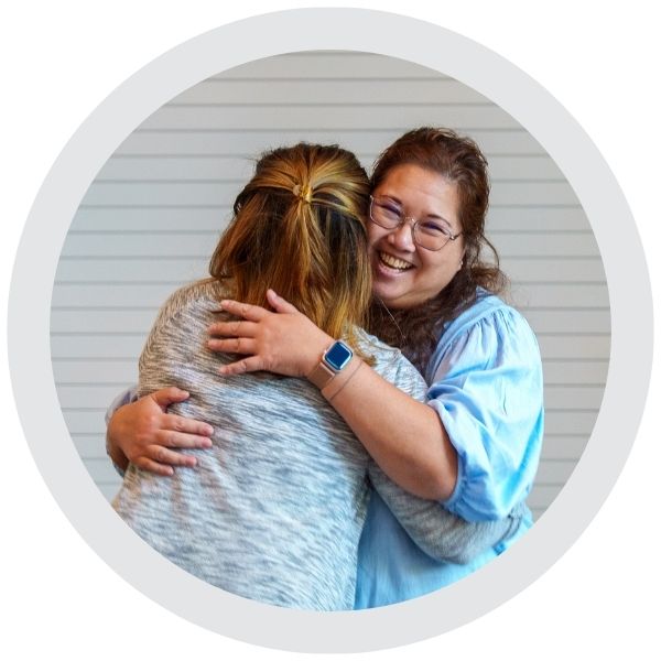 Two people embracing at a community work event