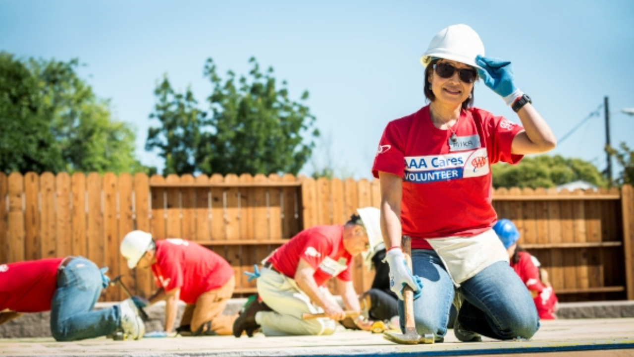 AAA Cares volunteers working together on a construction project during a community service event shown as a video thumbnail
