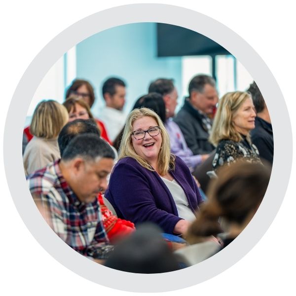 iA group of people seated in a room during a meeting or presentation.