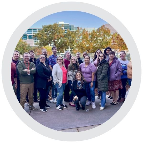  A group of employees standing together outdoors near an office building