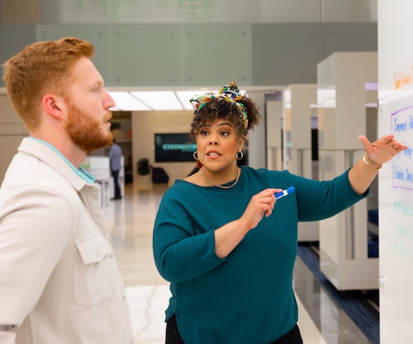 Employees working on a whiteboard