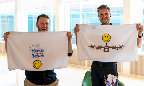 Two Salute members holding pillowcases for veterans