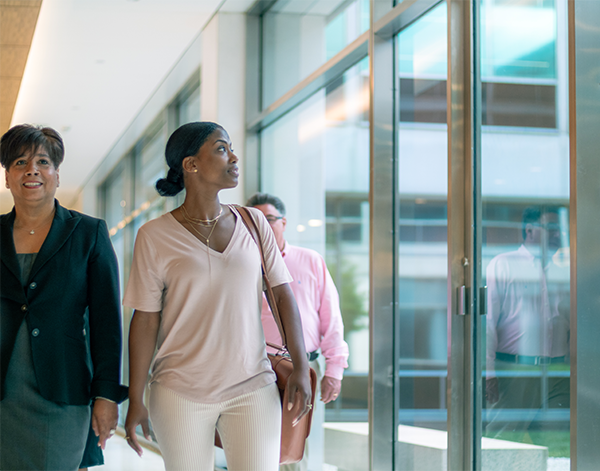 Employees walking together and smiling