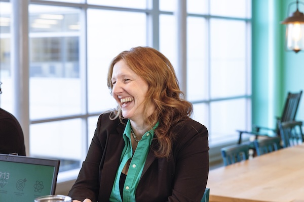 Evernorth employee laughing with colleagues at a conference table