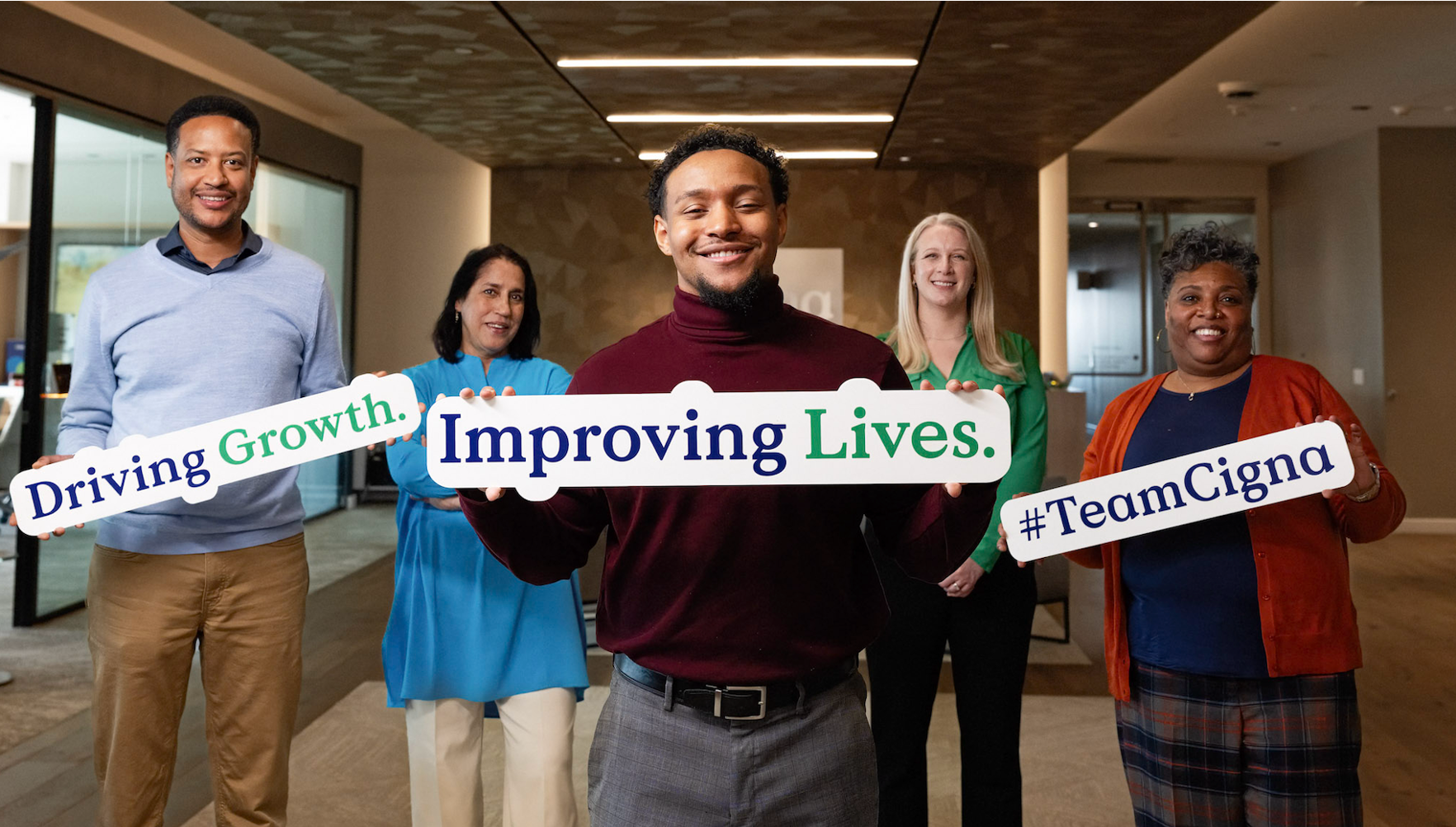 Employees holding #TeamCigna signs