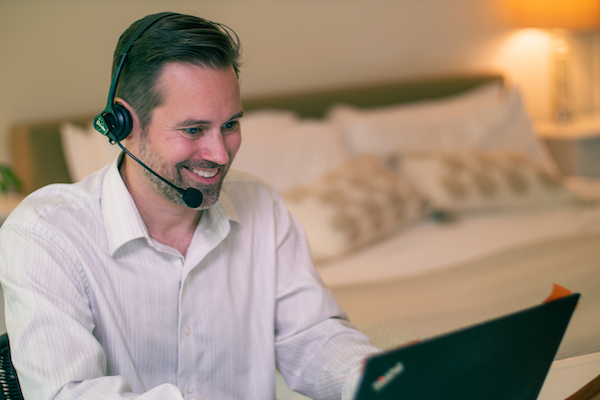 Man with headset on during conference call