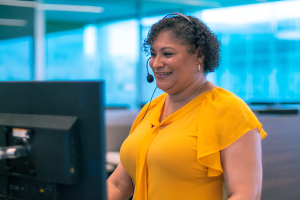 Woman smiling at her computer screen