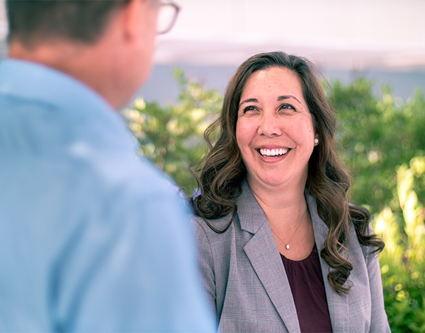 Woman talking to a colleague and smiling