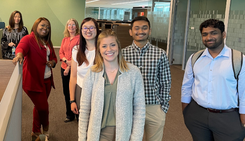 Group of associates posing for a large group photo