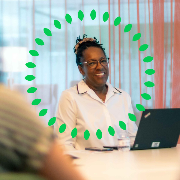 An employee sitting in front of her laptop participating in a team meeting
