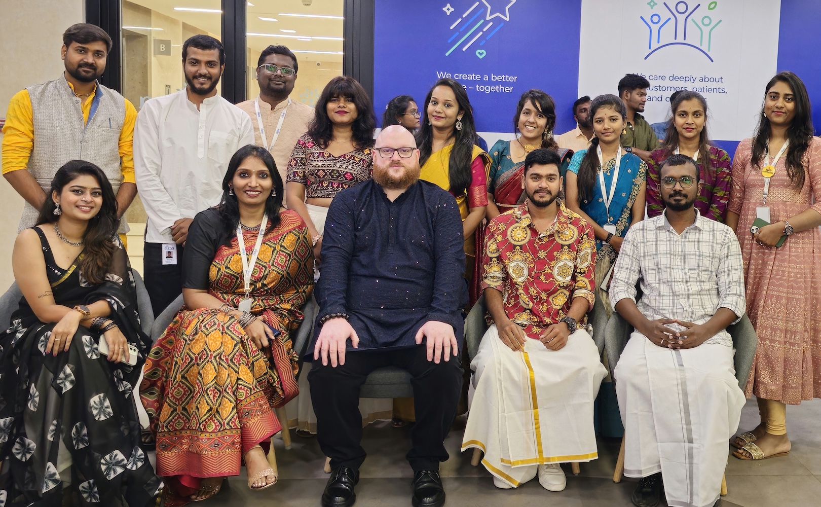 Employees in India smiling together for a photo