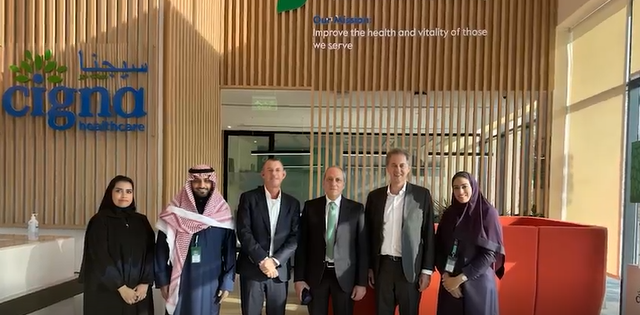 Saudi Arabia employees posing together in the office