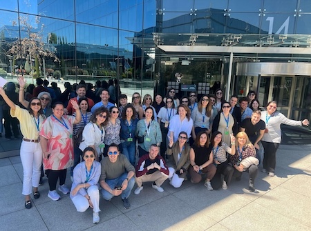 Spain employees posing in front of the office