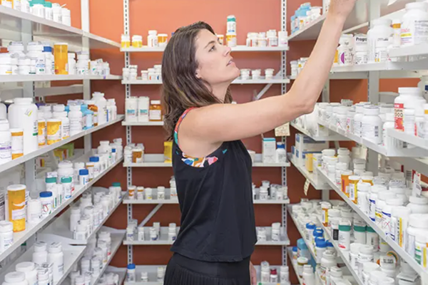 Employee reviewing perscriptions. 