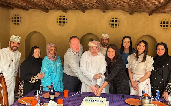 Group of employees from the Middle East posing during a celebration