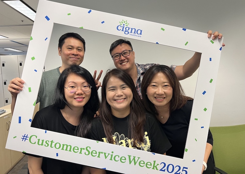 Singapore employees posing for a fun photo during Customer Service Week