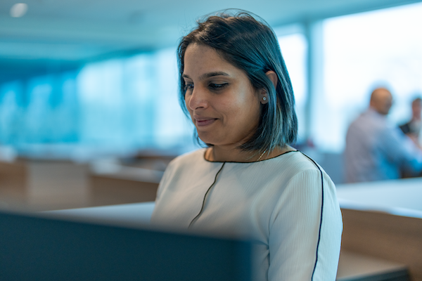 Smiling female working in front of computer