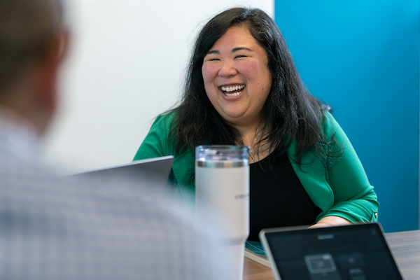 Employee smiling in a conference room