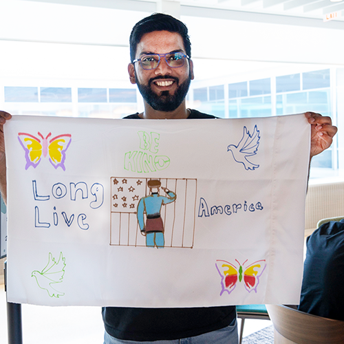 Salute ERG member holding up artwork