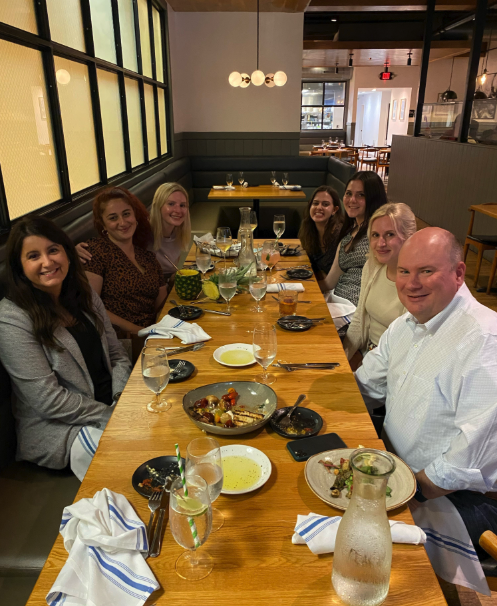 Associates posing at a program dinner
