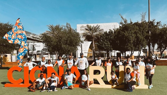 UAE employees posing in front of a Cigna Run sign