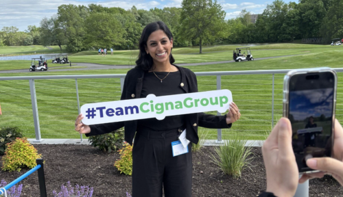 Associate holding a #TeamCignaGroup sign
