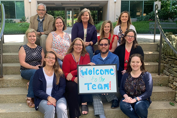 Team with welcome sign