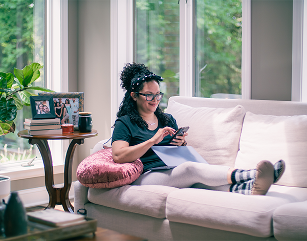 Employee working from her couch with her computer