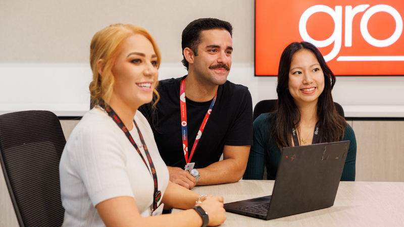 Three Coles corporate team members, two female, one male. All within the same meeting room.