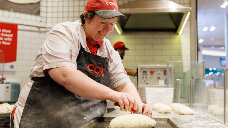 Female Coles bakers preparing bread dough