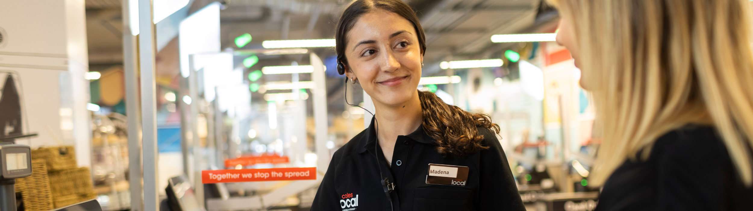 Coles Local employee serving a customer