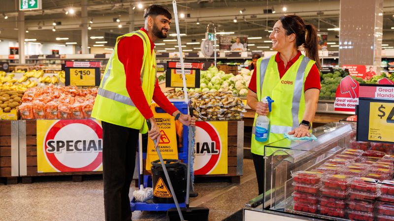 Two Coles services cleaners in a Coles supermarket